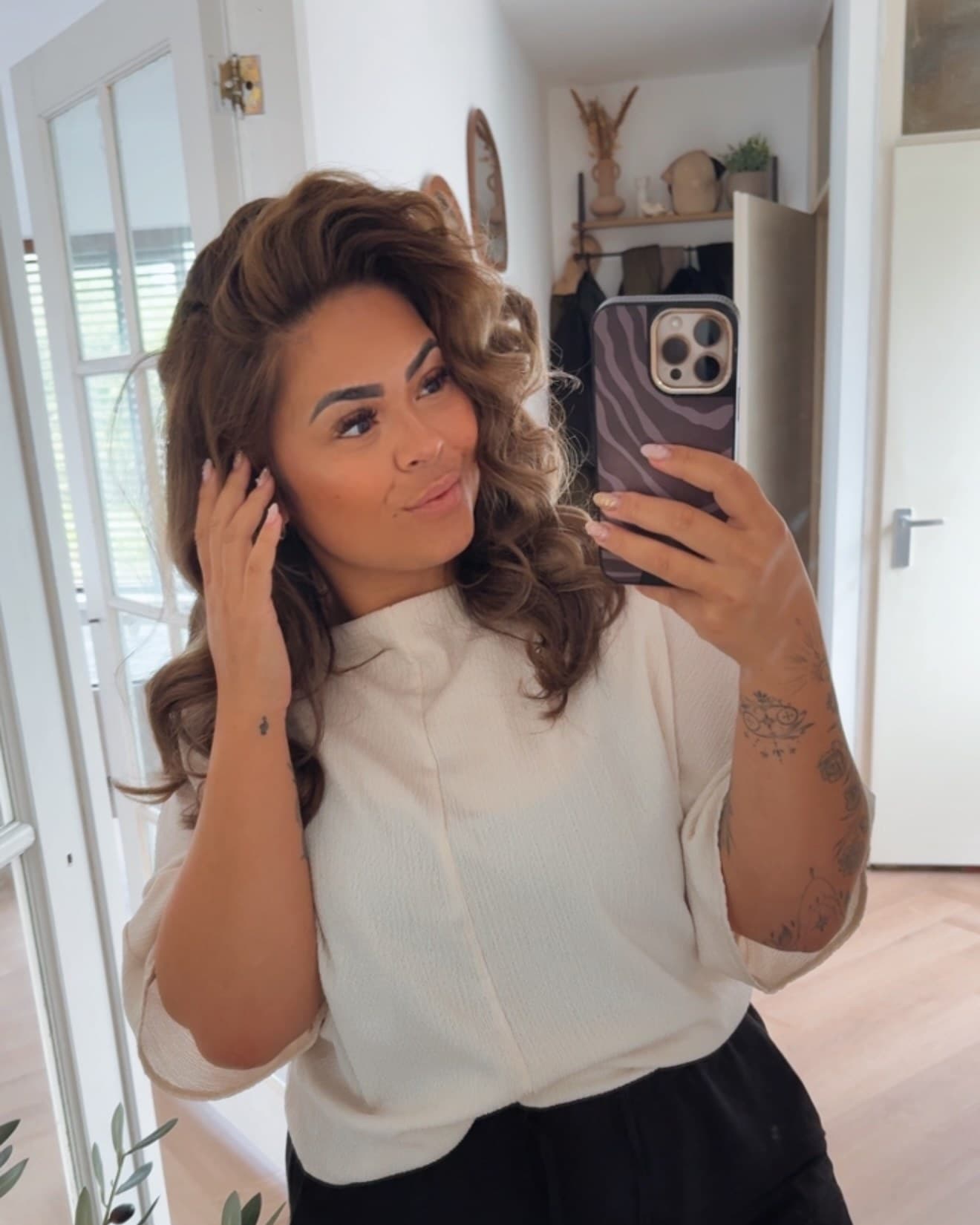 Michelle in her hallway in daylight, fresh curls