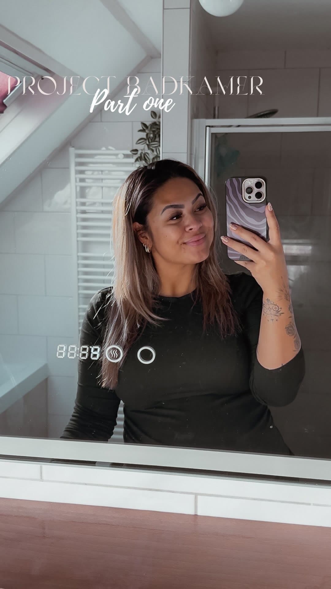 Michelle with a lit bathroom mirror